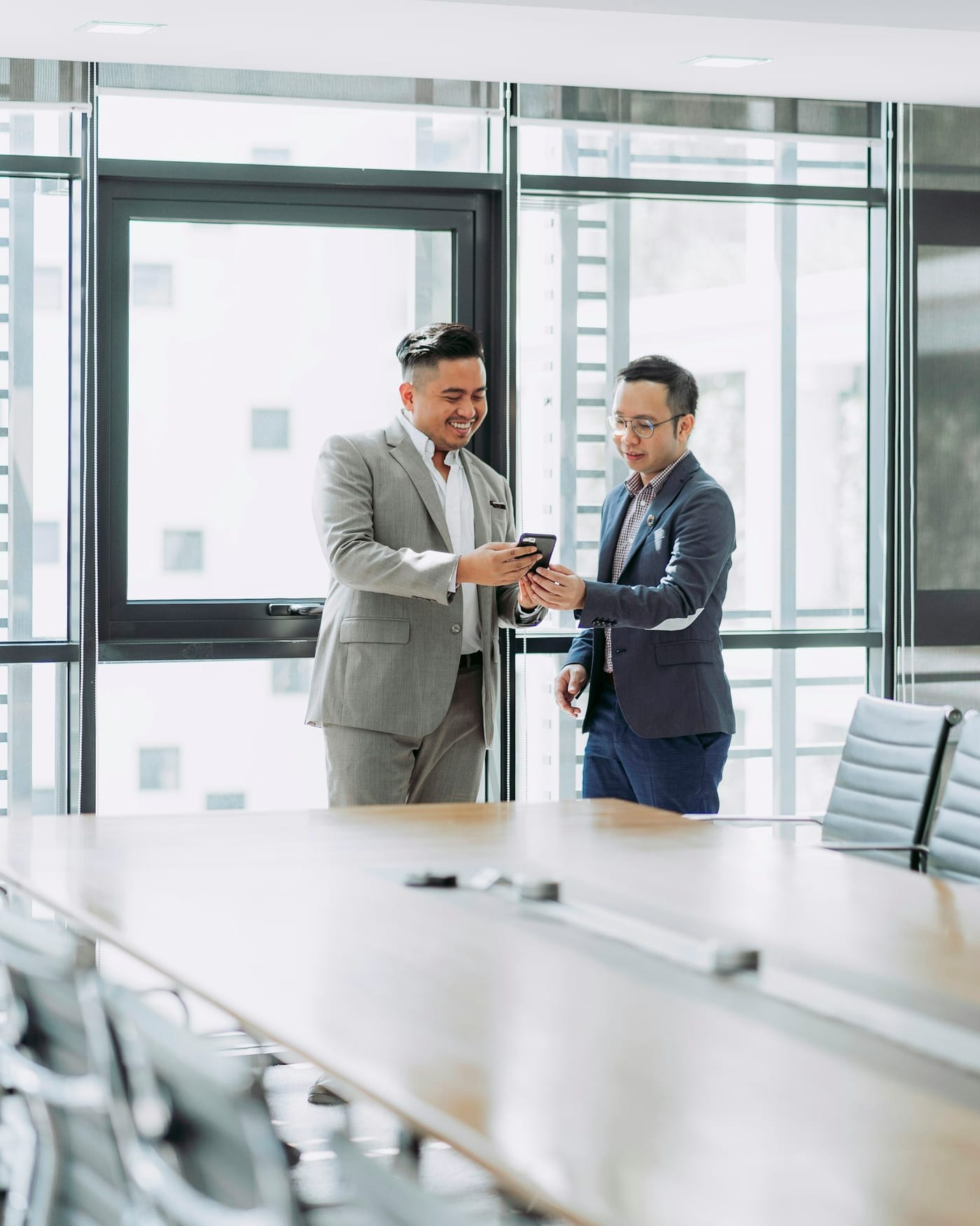 Two professionals talking in a Malaysian office